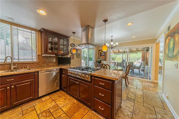 a kitchen with stainless steel appliances granite countertop sink stove and refrigerator