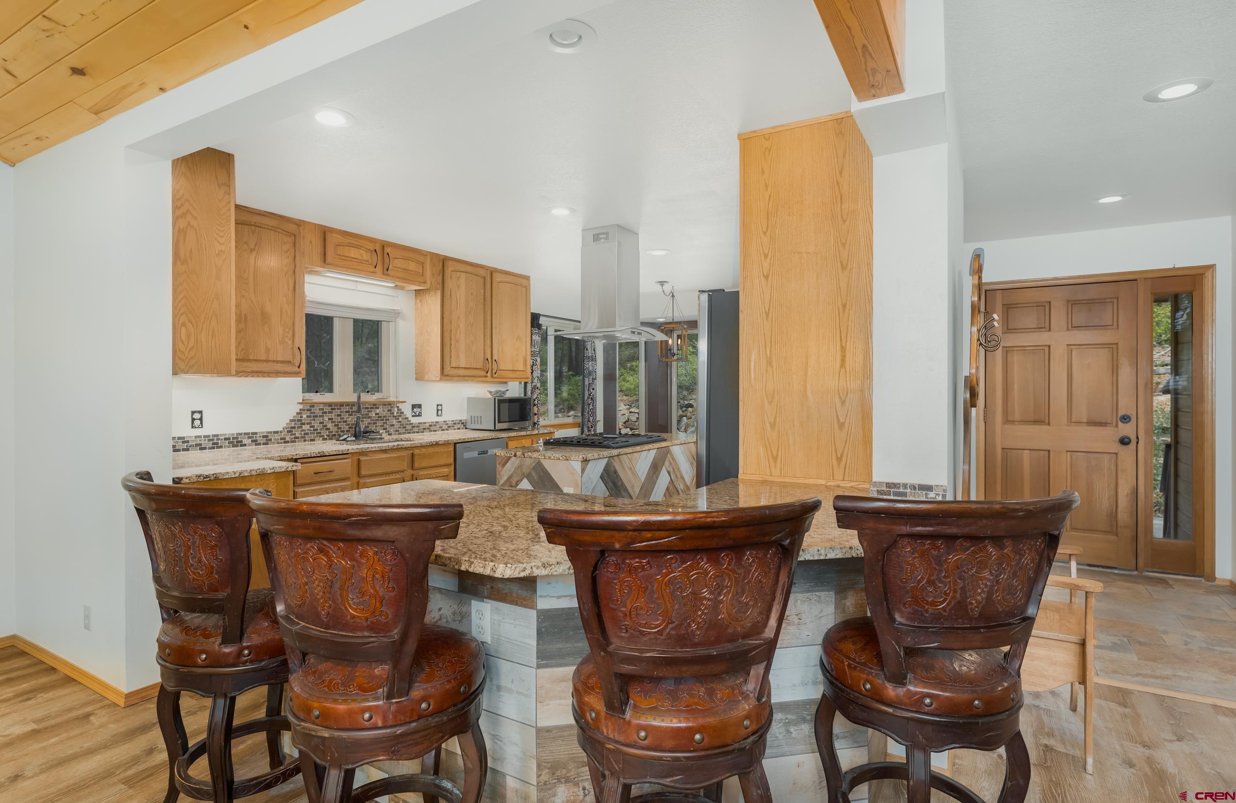 197 Buckhorn Road Bayfield, CO 81122 - Photo 6 of 34 a living room with a chairs and a dining table with wooden floor