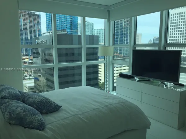 a bedroom with a bed and a television