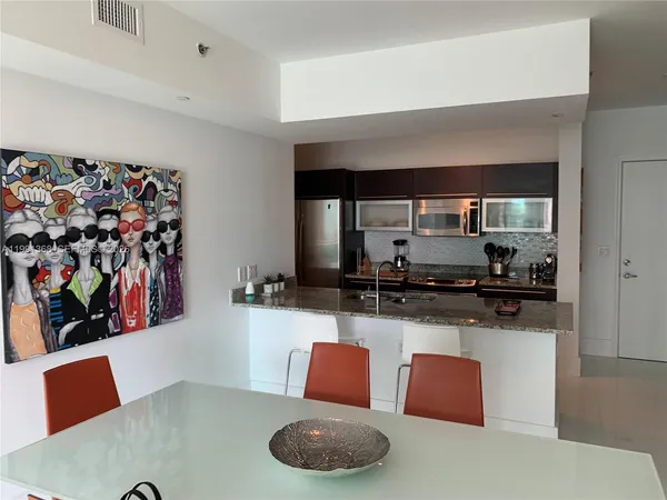 a kitchen with stainless steel appliances granite countertop a sink and a stove top oven