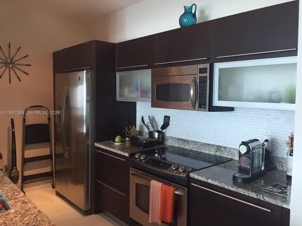 a kitchen with a sink and a refrigerator