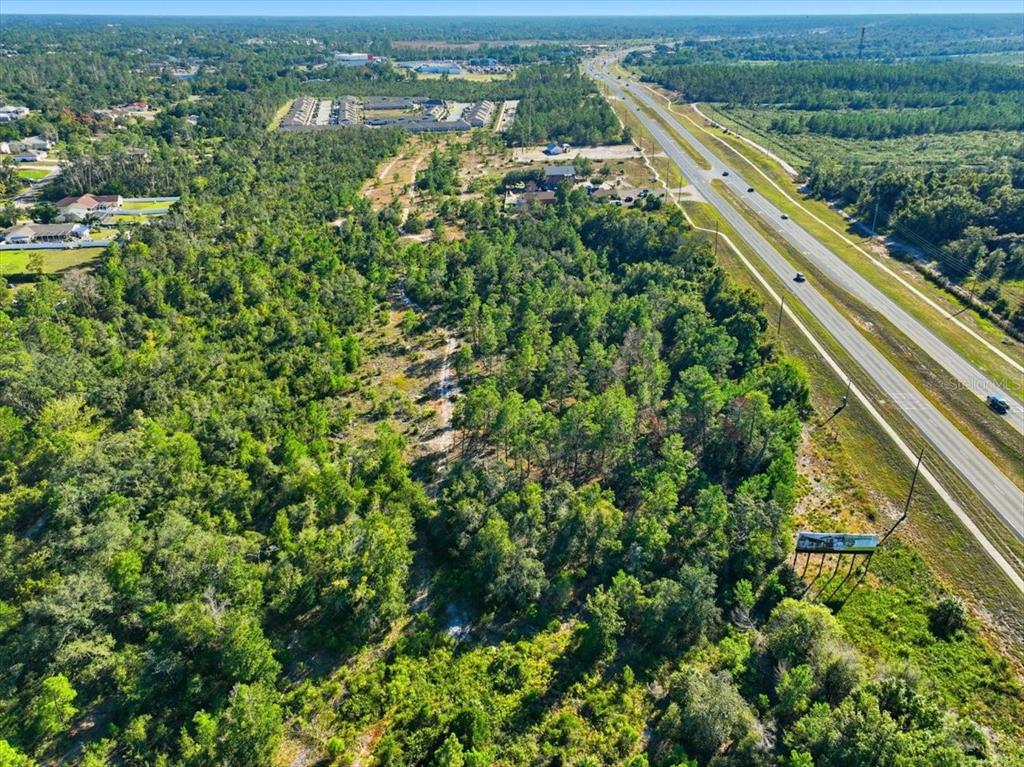 7124 Commercial Way Weeki Wachee, FL 34613 - Photo 15 of 30 an aerial view of residential houses with outdoor space and trees
