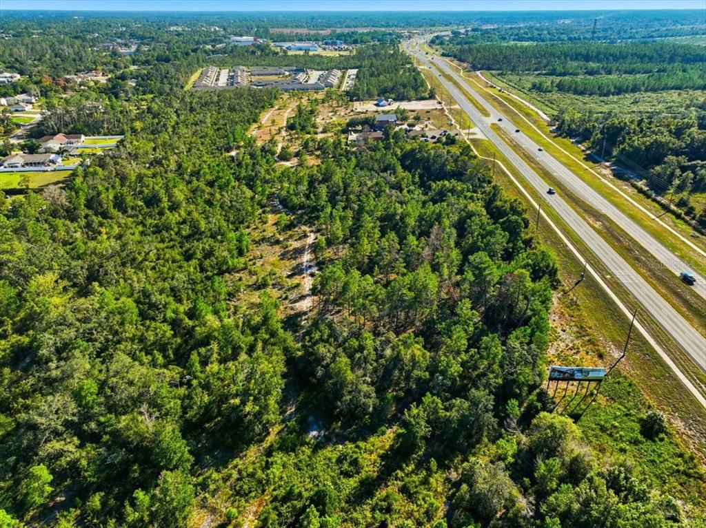 7124 Commercial Way Weeki Wachee, FL 34613 - Photo 21 of 30 an aerial view of residential houses with outdoor space and trees