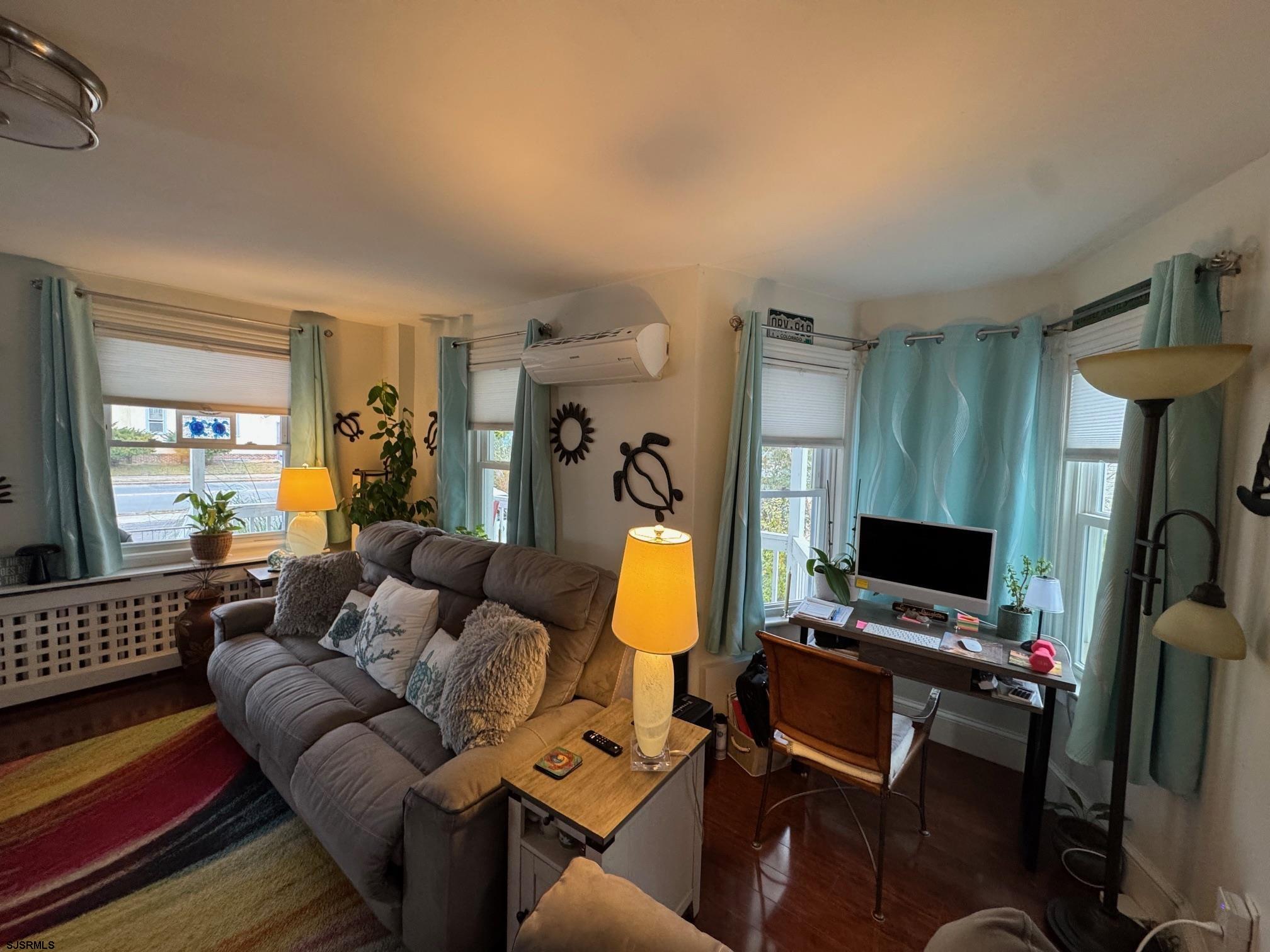 1801 Tilton Road Northfield, NJ 08225 - Photo 12 of 30 a living room with furniture and a flat screen tv