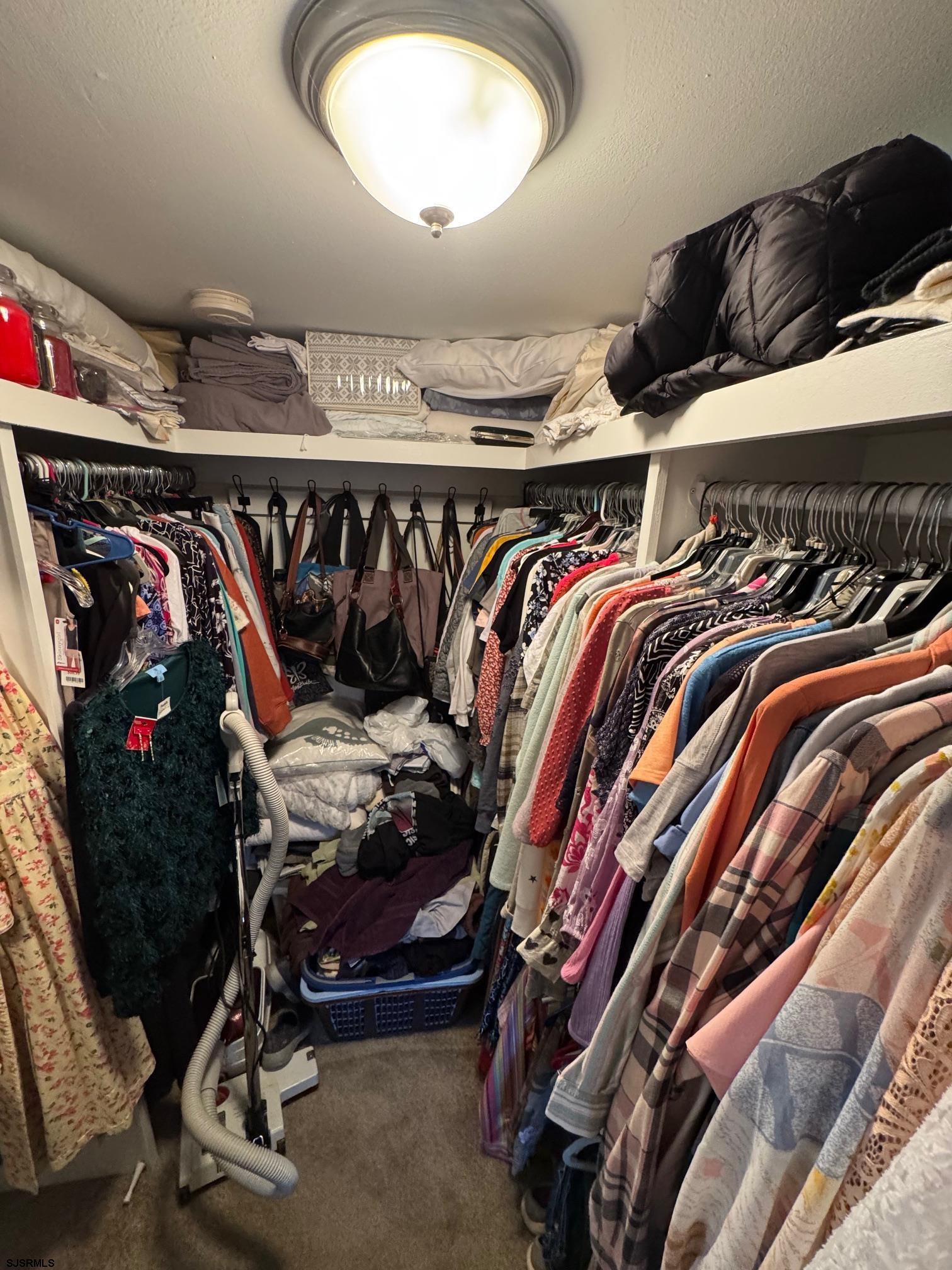 1801 Tilton Road Northfield, NJ 08225 - Photo 17 of 30 a view of walk in closet with clothes and shoes
