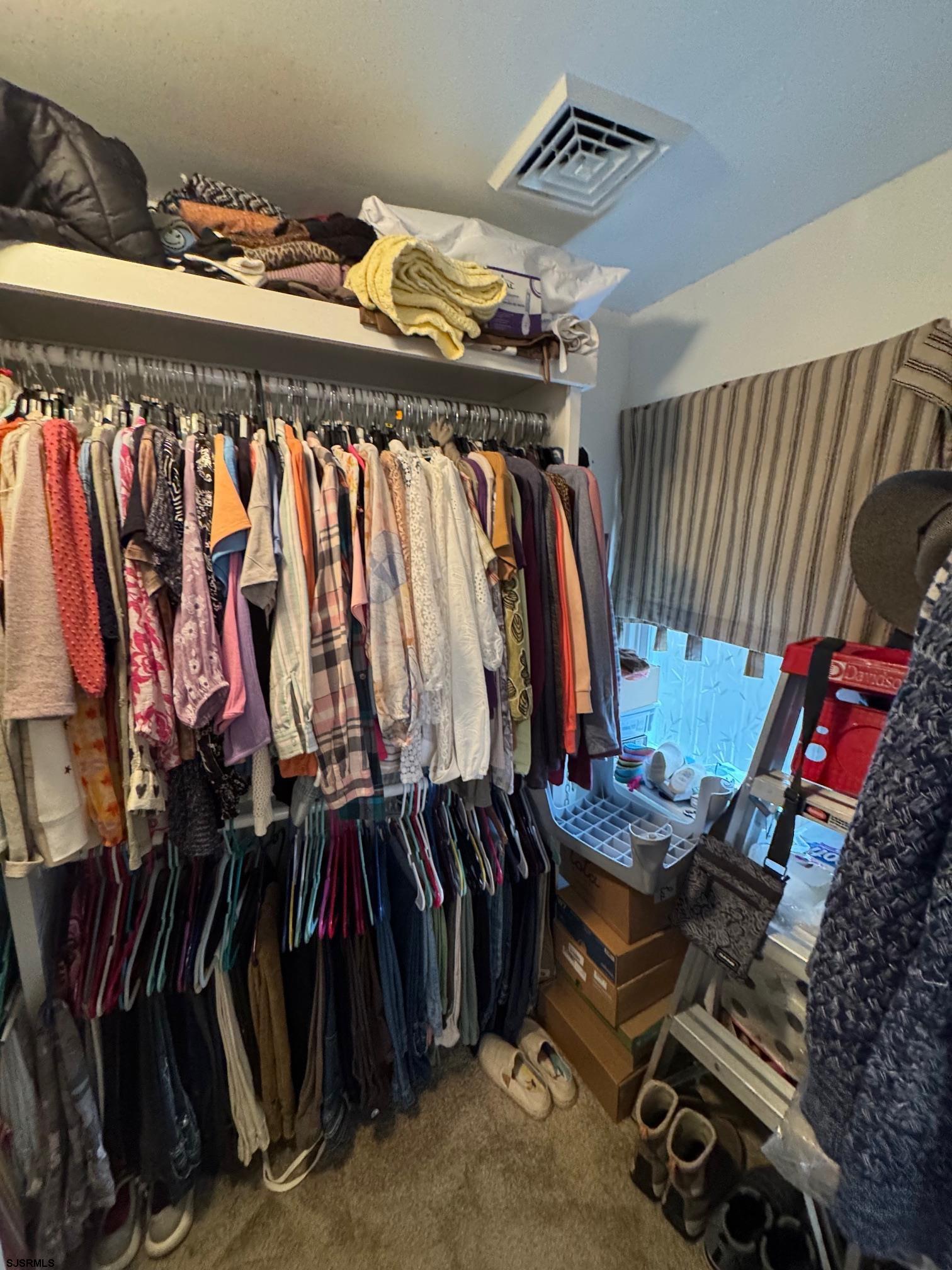 1801 Tilton Road Northfield, NJ 08225 - Photo 18 of 30 a view of walk in closet with clothes and shoes