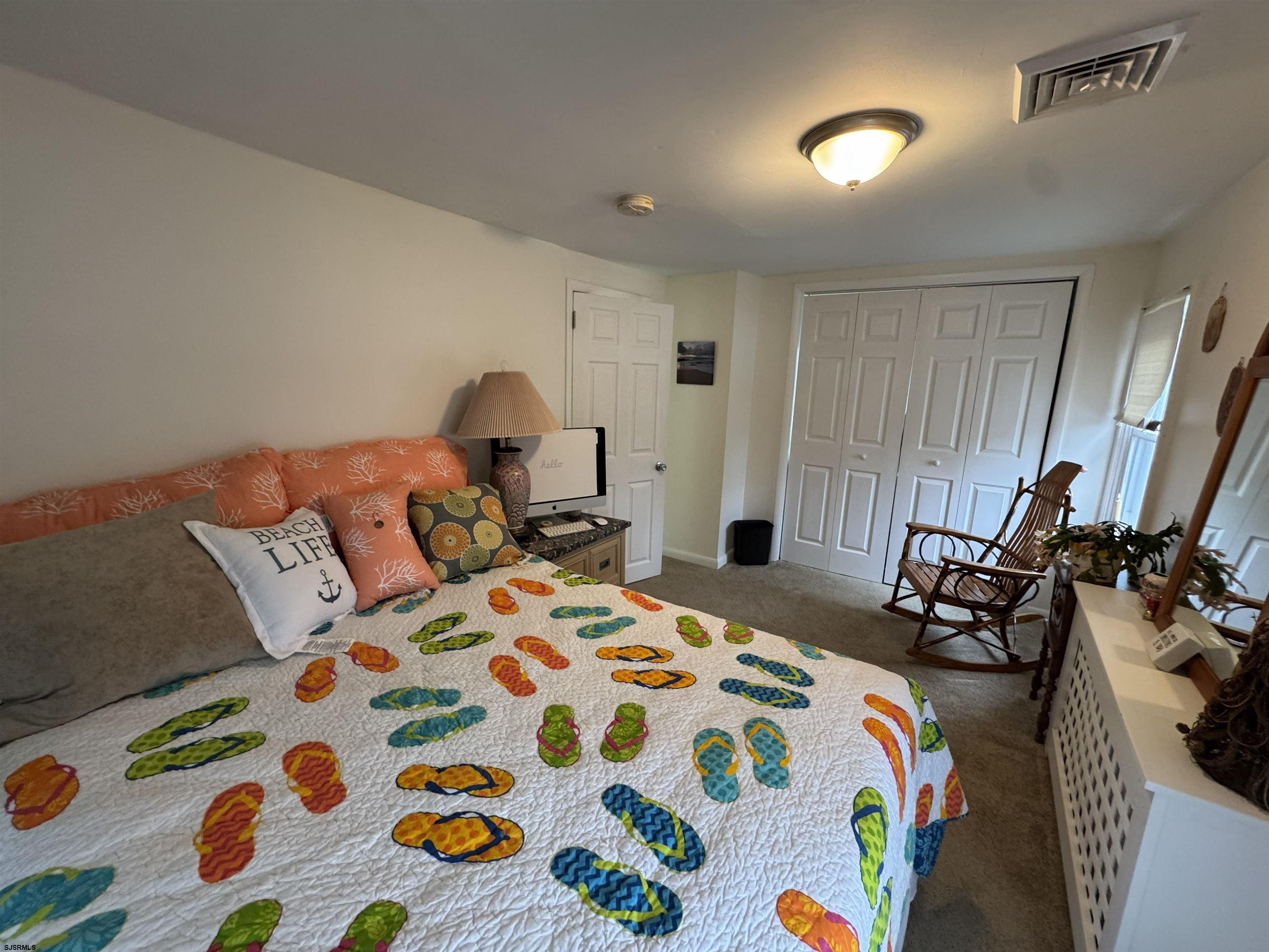 1801 Tilton Road Northfield, NJ 08225 - Photo 23 of 30 a bedroom with a bed and a lamp