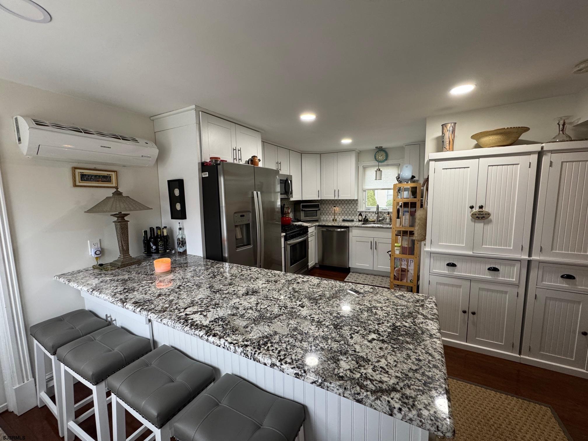 1801 Tilton Road Northfield, NJ 08225 - Photo 6 of 30 a kitchen with stainless steel appliances kitchen island granite countertop a refrigerator and a sink