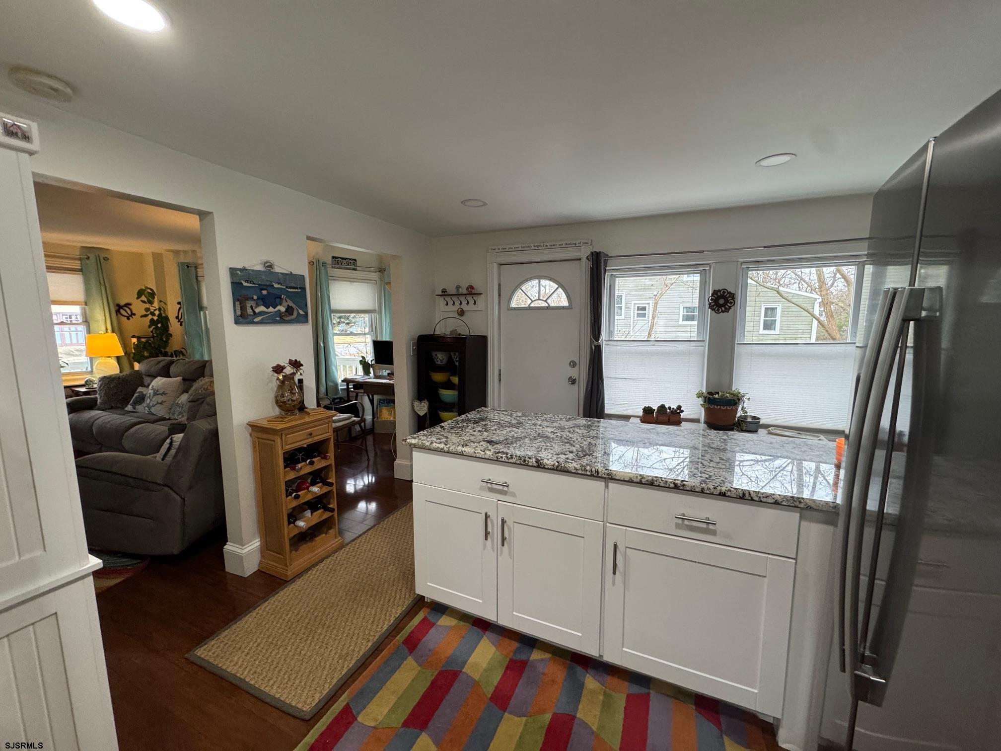 1801 Tilton Road Northfield, NJ 08225 - Photo 8 of 30 a kitchen with granite countertop a sink stove and cabinets