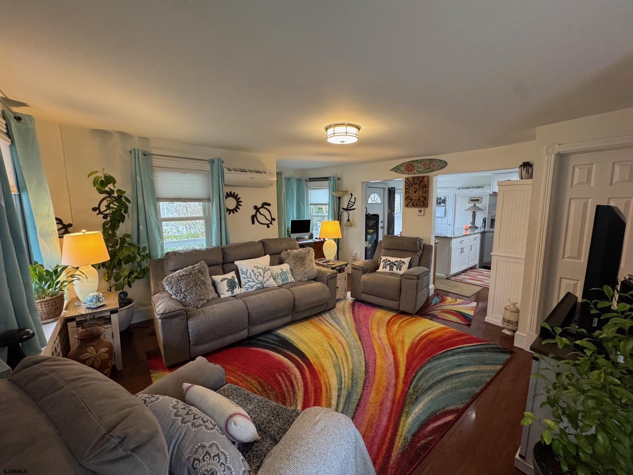 1801 Tilton Road Northfield, NJ 08225 - Photo 10 of 30 a living room with furniture and a flat screen tv