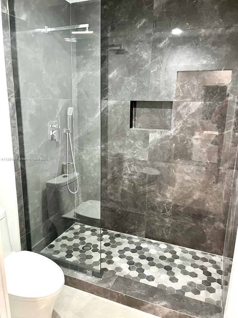 3530 Mystic Pointe Drive, Unit PH08 Aventura, FL 33180 - Photo 11 of 11 a bathroom with a sink and a shower