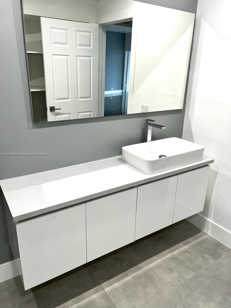 3530 Mystic Pointe Drive, Unit PH08 Aventura, FL 33180 - Photo 4 of 11 a bathroom with a sink and a mirror
