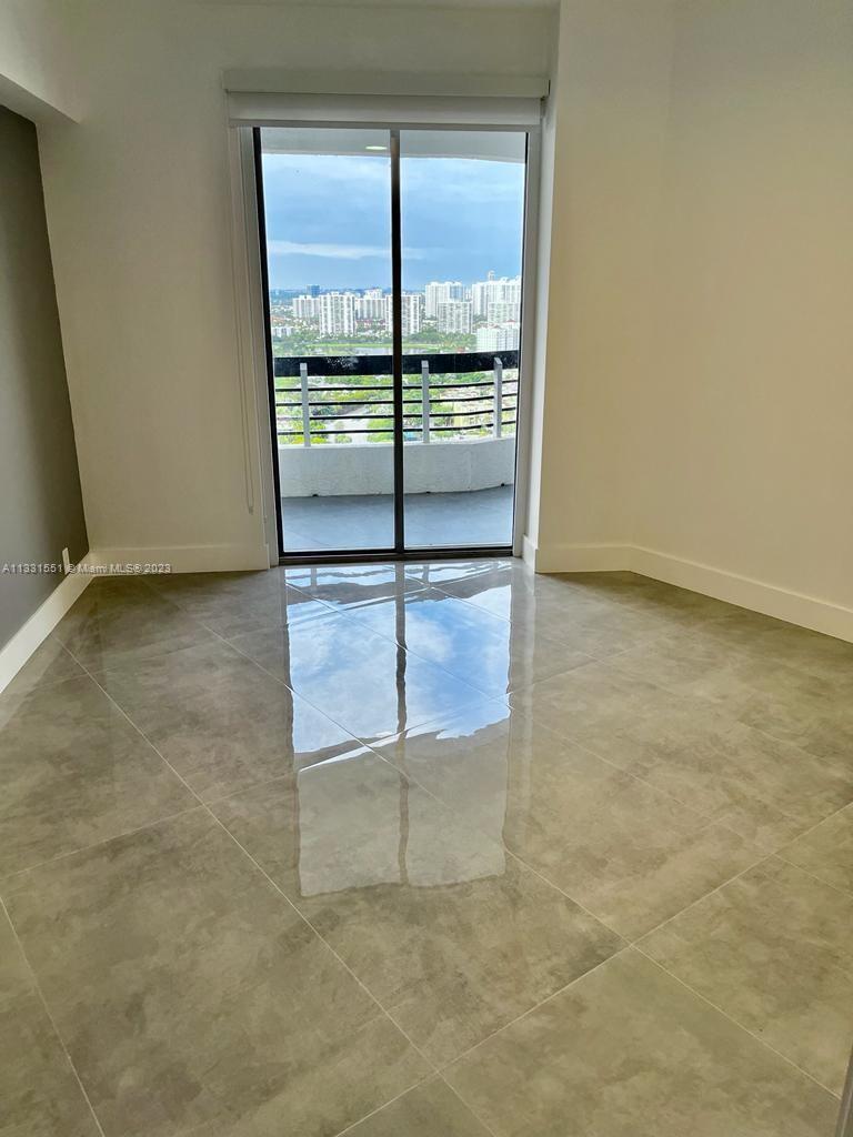 3530 Mystic Pointe Drive, Unit PH08 Aventura, FL 33180 - Photo 6 of 11 an empty room with wooden floor and windows