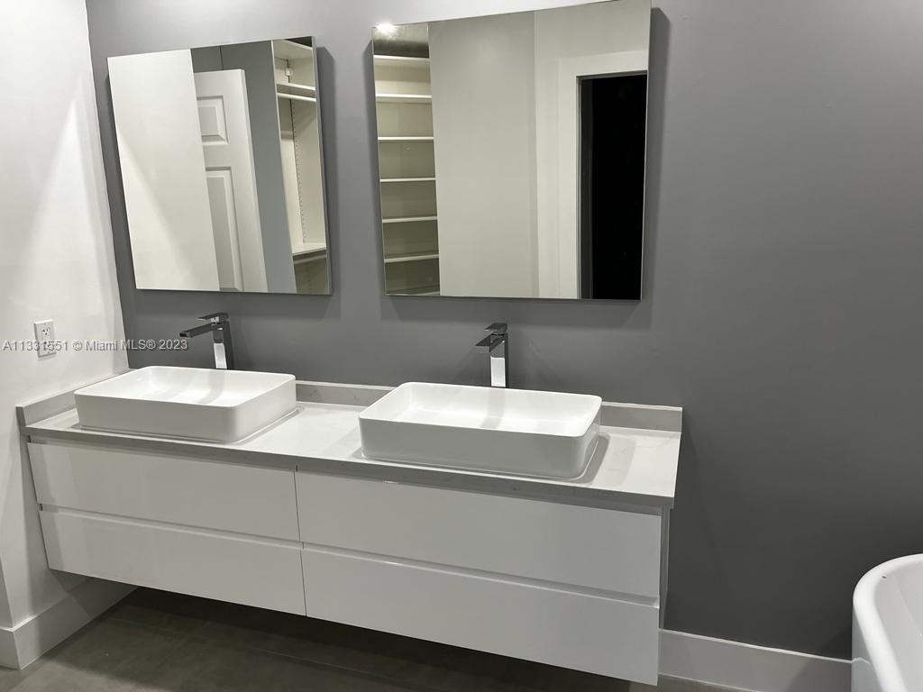 3530 Mystic Pointe Drive, Unit PH08 Aventura, FL 33180 - Photo 9 of 11 a bathroom with a sink and a mirror