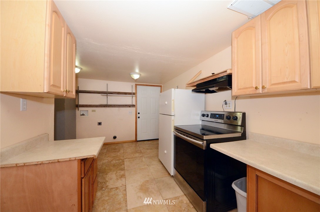 18224 Pendleton Street Southwest Rochester, WA 98579 - Photo 26 of 35 a kitchen with stainless steel appliances granite countertop a sink stove and refrigerator