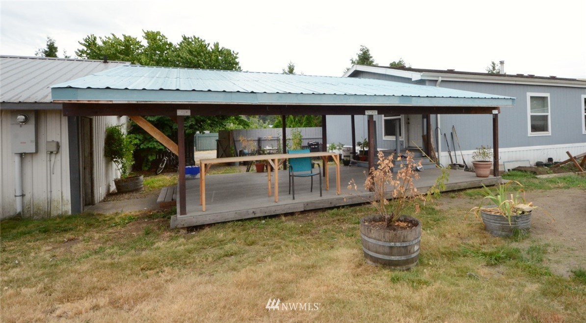 18224 Pendleton Street Southwest Rochester, WA 98579 - Photo 32 of 35 a view of a house with backyard outdoor seating area and furniture