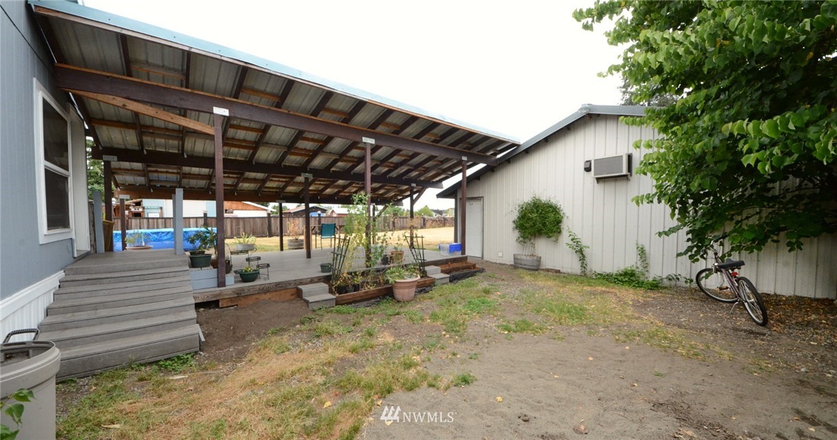 18224 Pendleton Street Southwest Rochester, WA 98579 - Photo 34 of 35 a view of a backyard with lawn chairs and a large tree