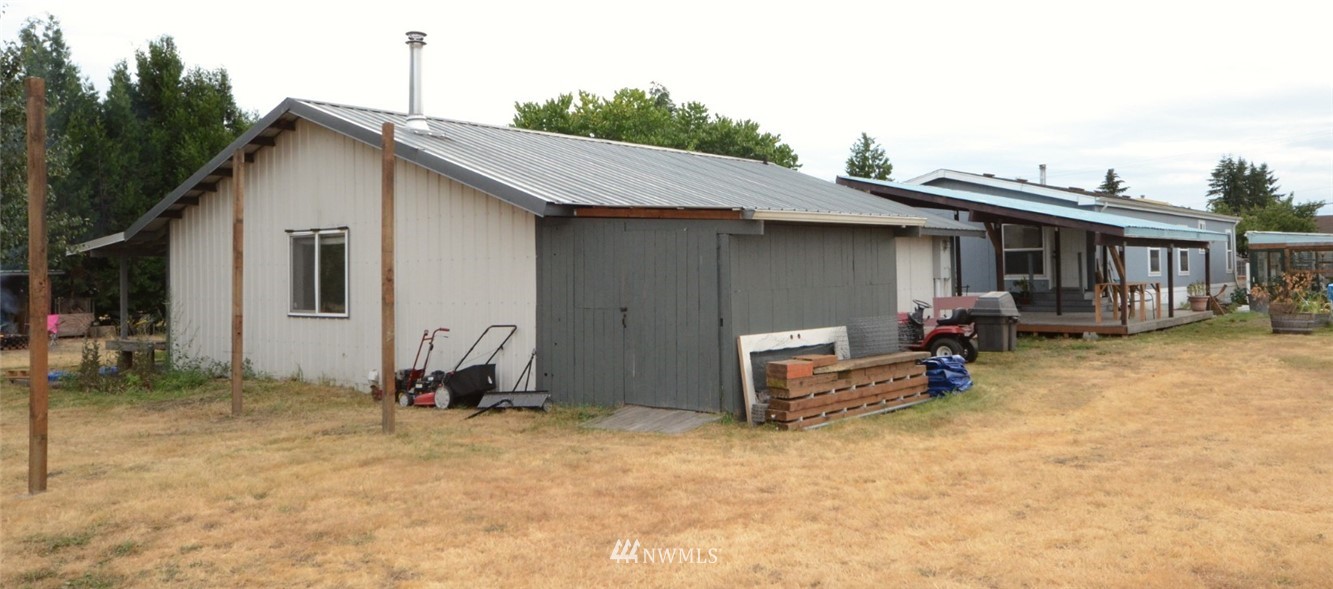 18224 Pendleton Street Southwest Rochester, WA 98579 - Photo 35 of 35 a backyard of a house with barbeque oven table and chairs