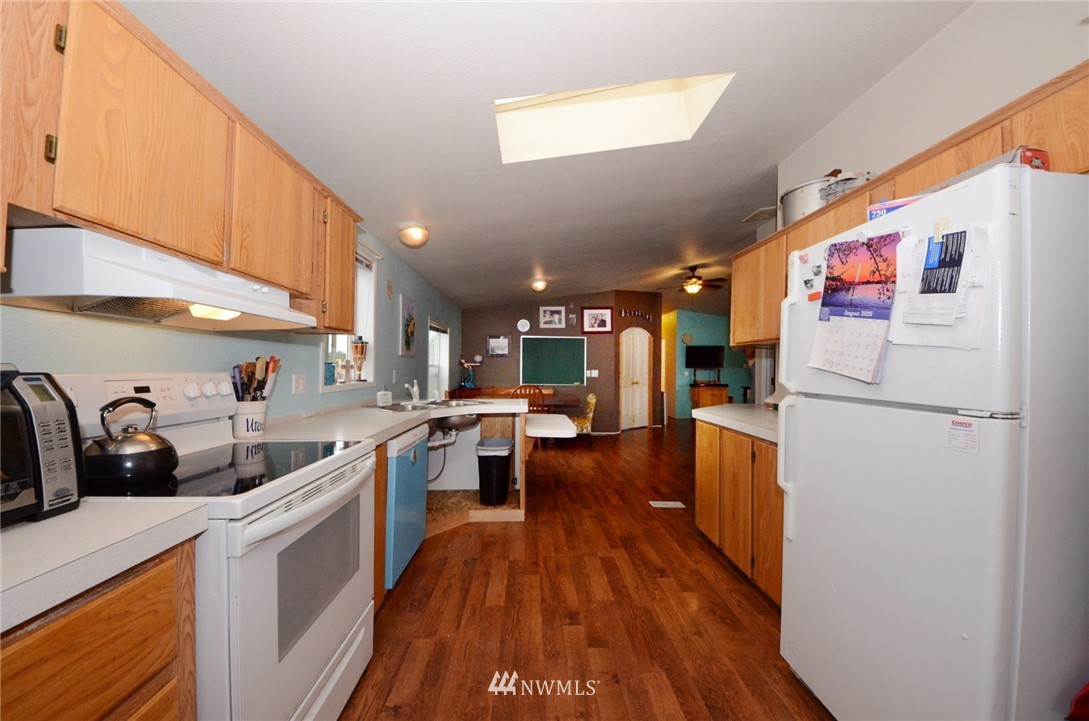 18224 Pendleton Street Southwest Rochester, WA 98579 - Photo 8 of 35 a kitchen with stainless steel appliances a sink a stove top oven a counter space and cabinets