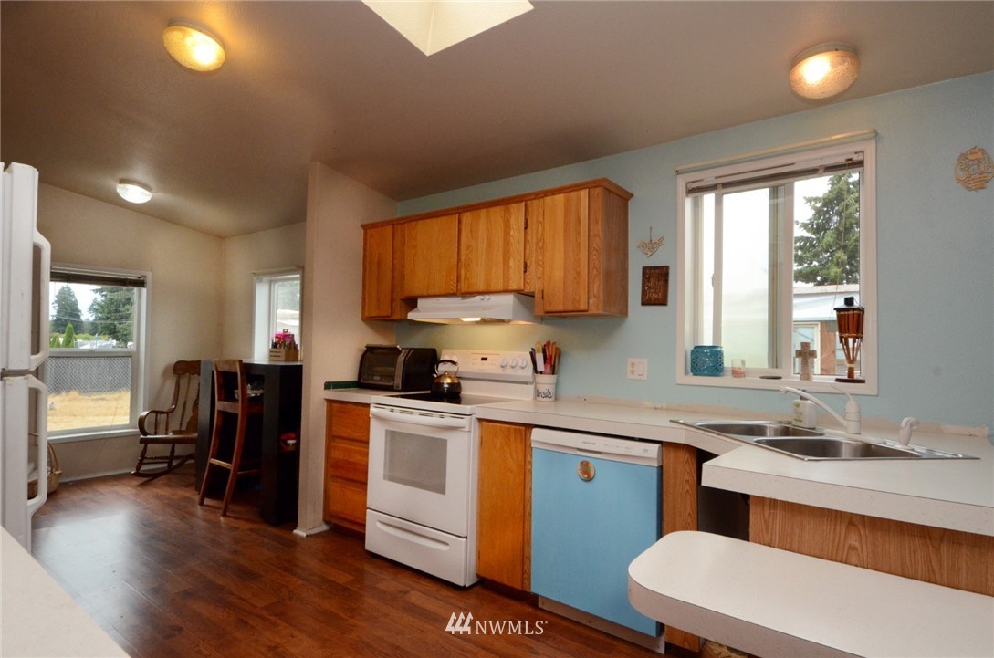 18224 Pendleton Street Southwest Rochester, WA 98579 - Photo 10 of 35 a kitchen with a sink cabinets and wooden floor