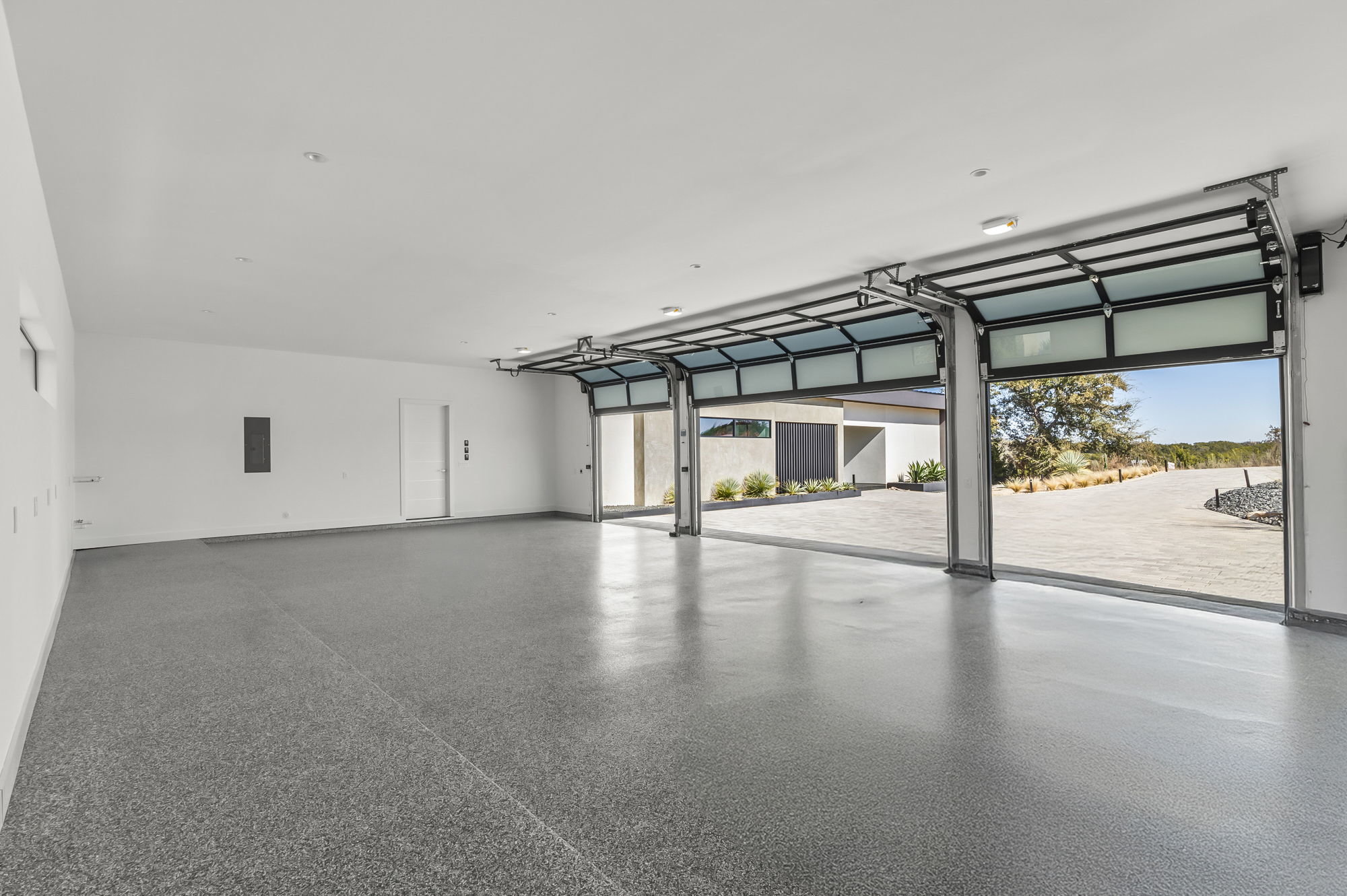 1702 Moonlight Trace Spicewood, TX 78669 - Photo 38 of 40 Garage with baseboards and electric panel