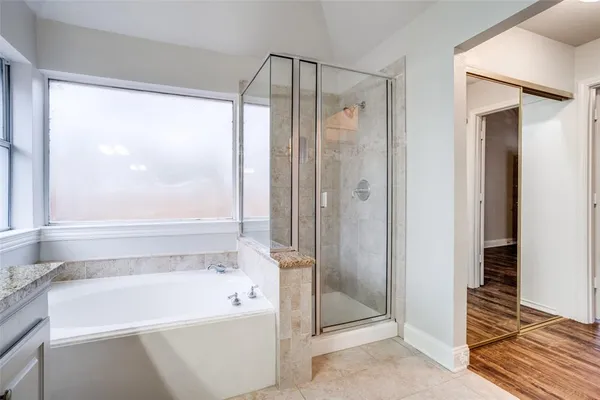 a bathroom with a bathtub and a shower
