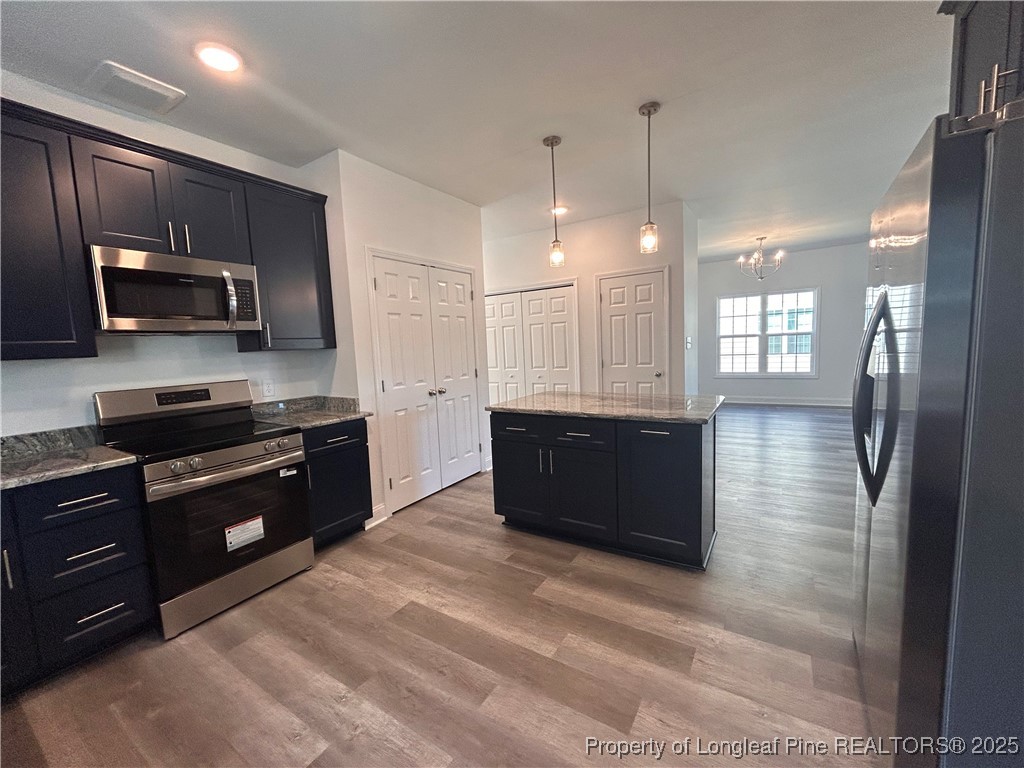 407 Morehead Street Spring Lake, NC 28390 - Photo 4 of 12 a large kitchen with kitchen island granite countertop stainless steel appliances and a sink