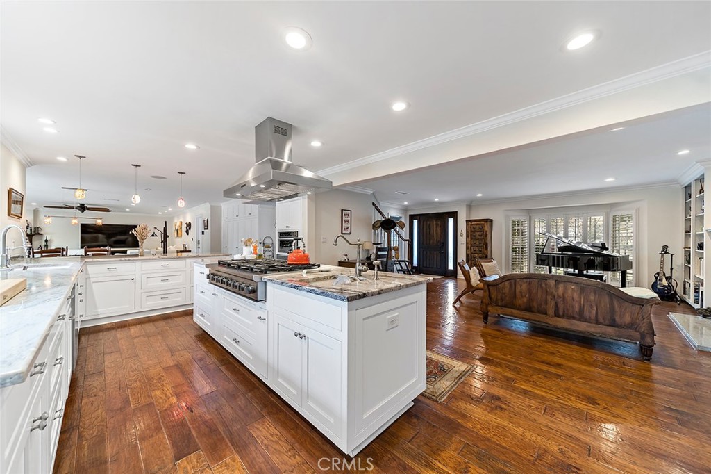 11792 Silver Fox Road Rossmoor, CA 90720 - Photo 49 of 49 a large kitchen with stainless steel appliances kitchen island granite countertop a large counter top and view of living room