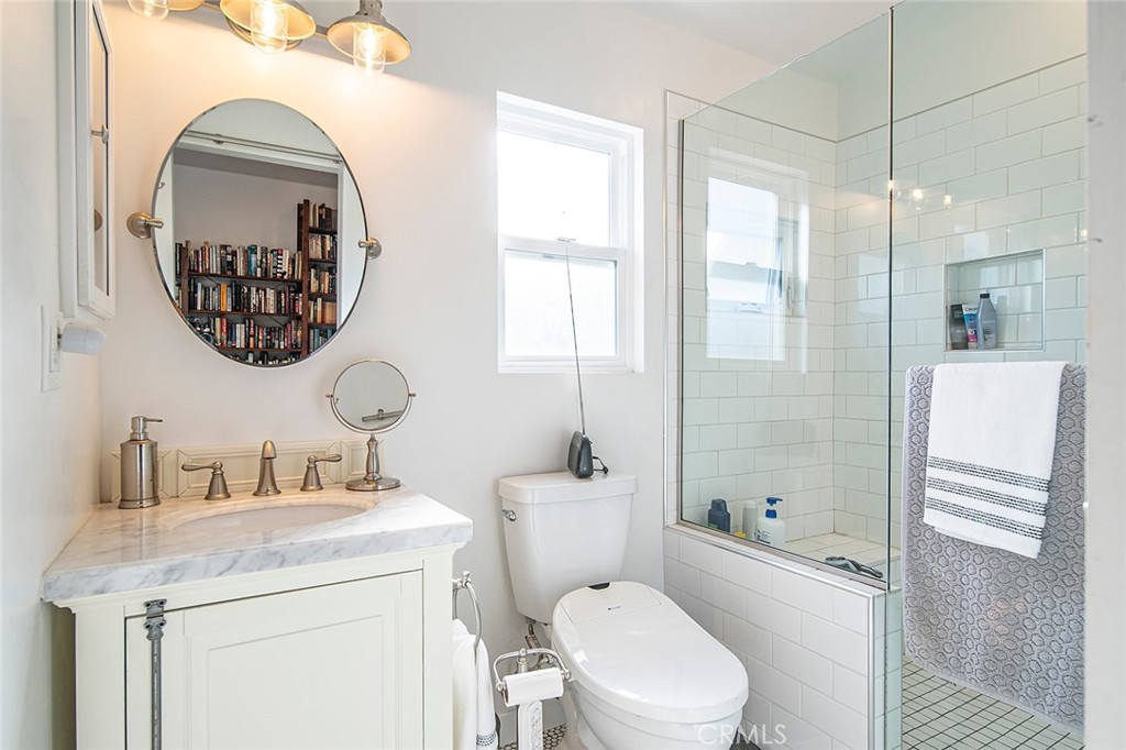 11792 Silver Fox Road Rossmoor, CA 90720 - Photo 30 of 49 a bathroom with a sink a toilet and a mirror