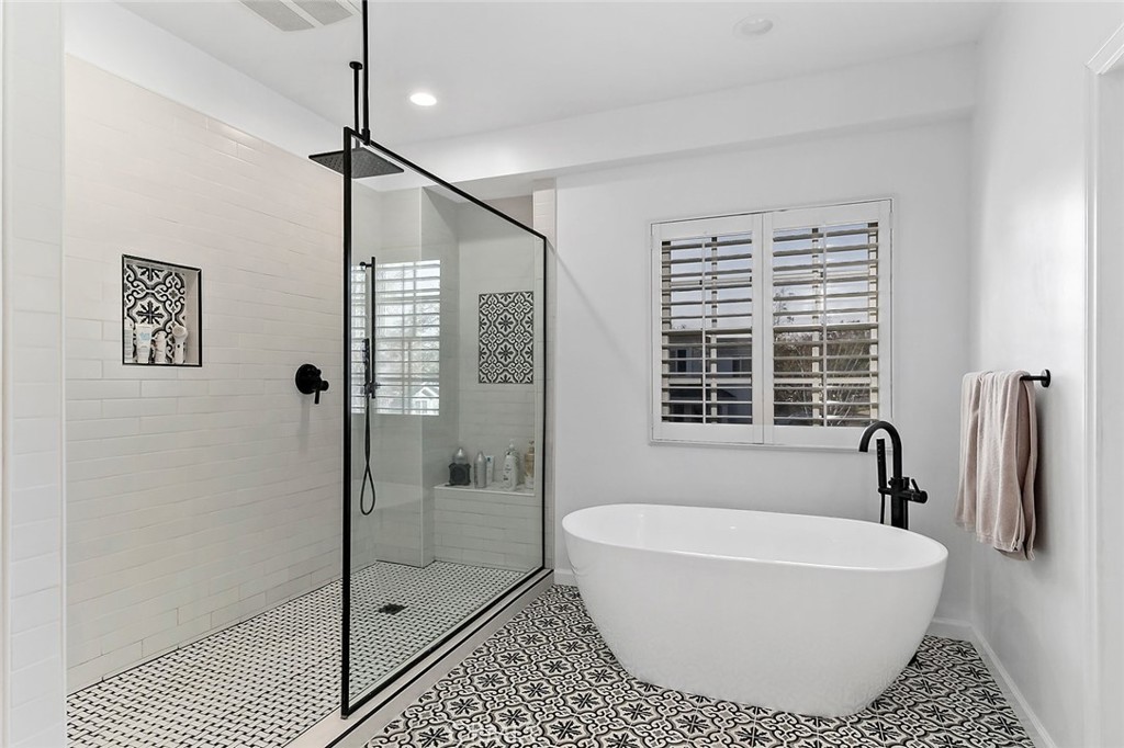 11792 Silver Fox Road Rossmoor, CA 90720 - Photo 33 of 49 a bathroom with a bathtub and shower