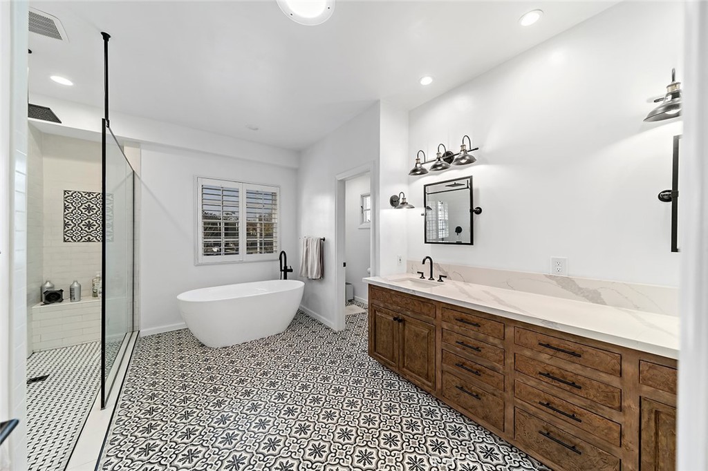 11792 Silver Fox Road Rossmoor, CA 90720 - Photo 34 of 49 a spacious bathroom with a bathtub sink and mirror