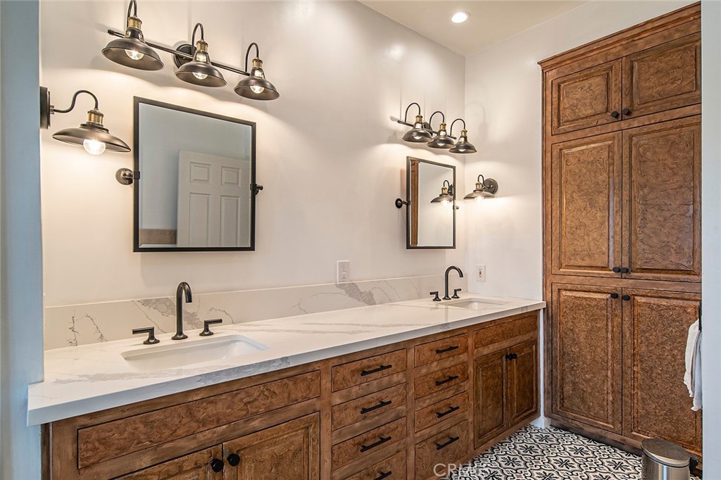 11792 Silver Fox Road Rossmoor, CA 90720 - Photo 36 of 49 a bathroom with a sink double vanity and a mirror