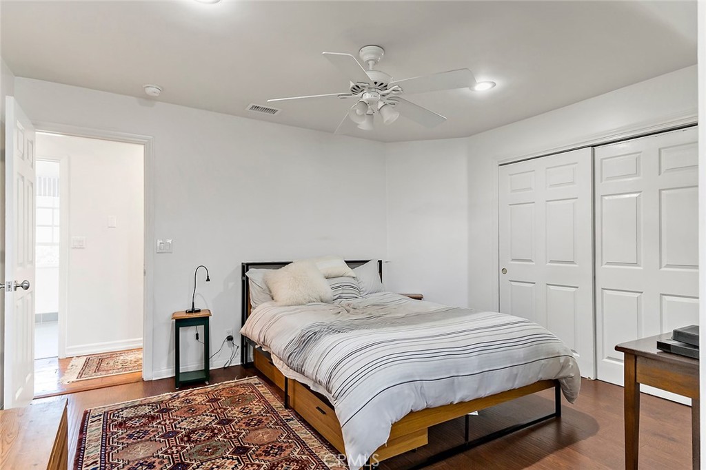 11792 Silver Fox Road Rossmoor, CA 90720 - Photo 38 of 49 a bedroom with a large bed and a chandelier