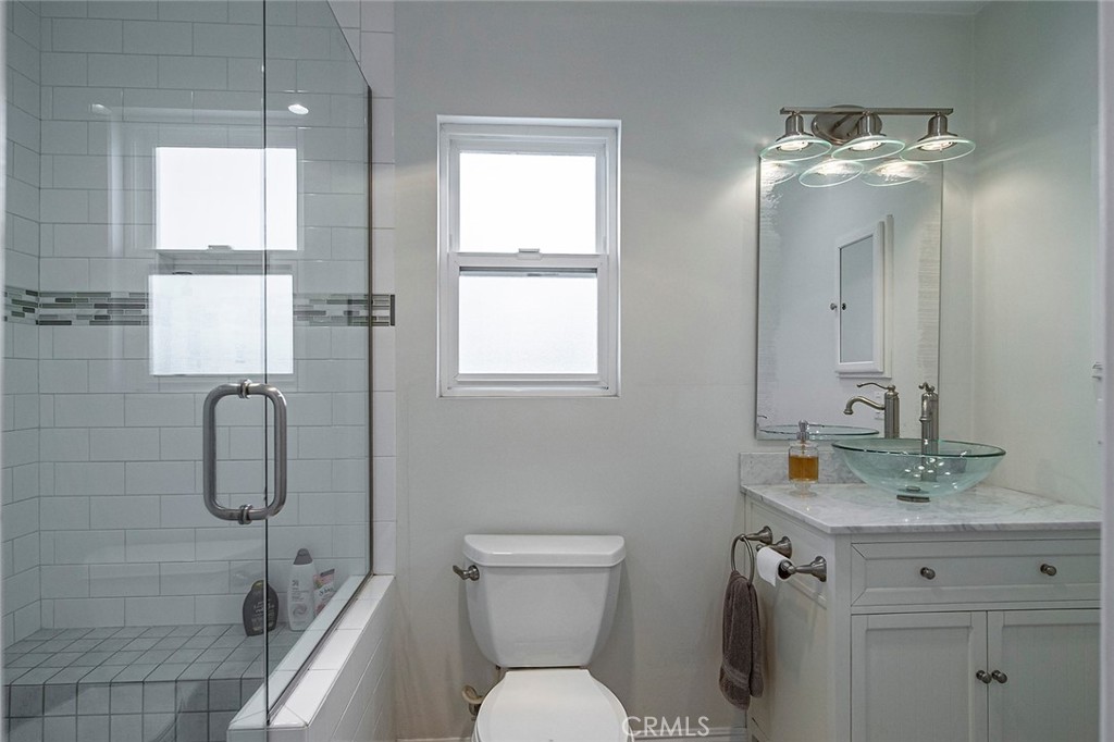 11792 Silver Fox Road Rossmoor, CA 90720 - Photo 44 of 49 a bathroom with a toilet sink shower and mirror