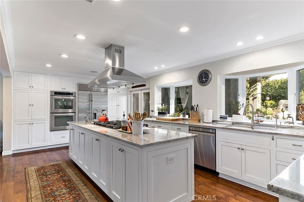 11792 Silver Fox Road Rossmoor, CA 90720 - Photo 6 of 49 a kitchen with stainless steel appliances a sink stove and cabinets