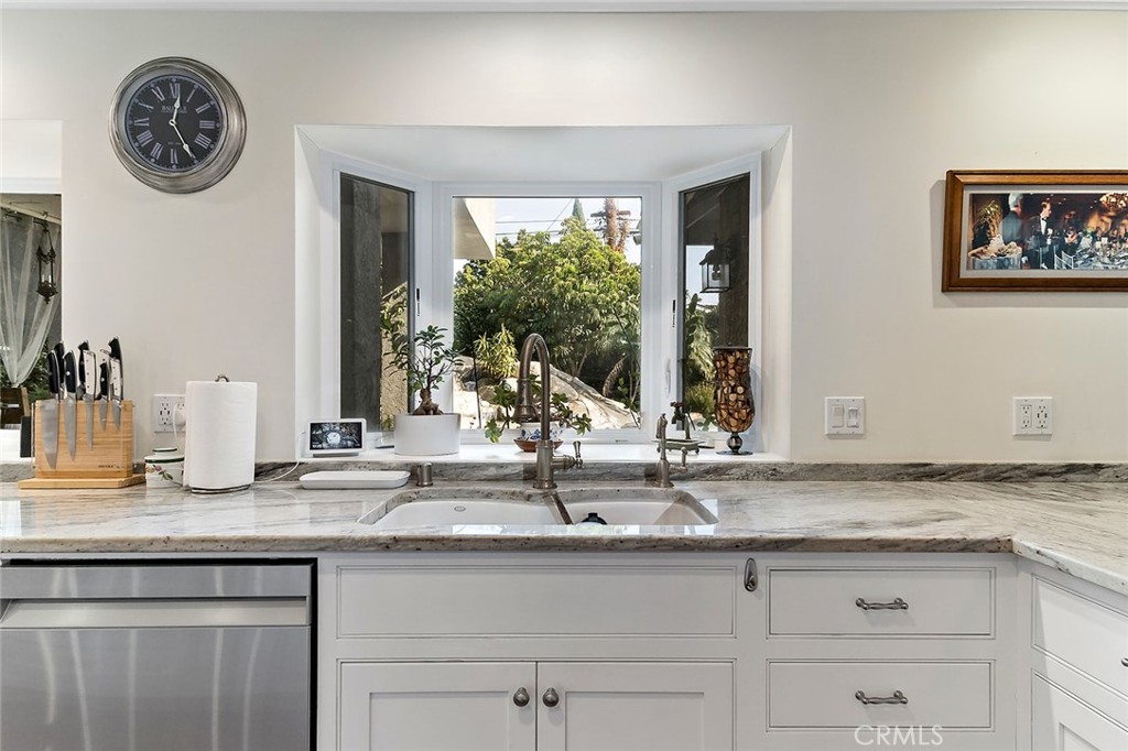 11792 Silver Fox Road Rossmoor, CA 90720 - Photo 8 of 49 a bathroom with a granite countertop sink and a large mirror