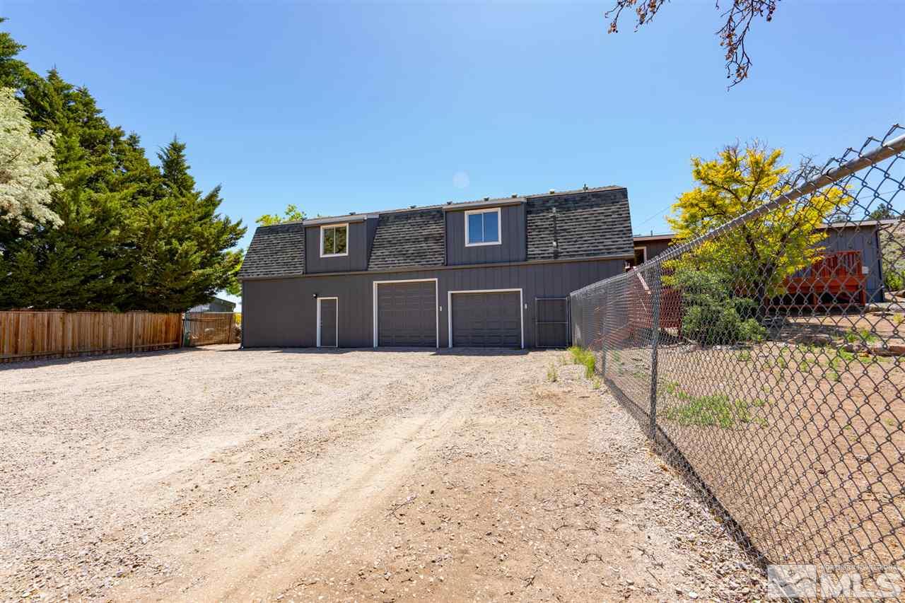 115 Silverstone Place Reno, NV 89512 - Photo 5 of 32 a front view of a house with a yard and garage