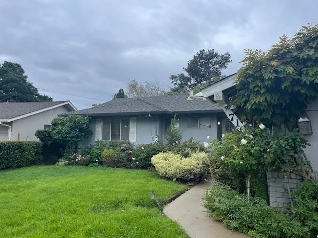 a front view of a house with garden