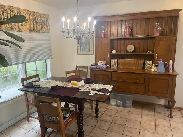 a view of a dining room with furniture and chandelier