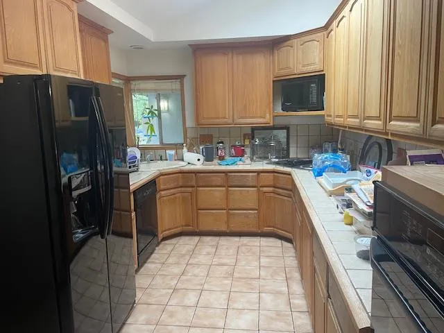 a kitchen with a sink a counter top space stainless steel appliances and cabinets