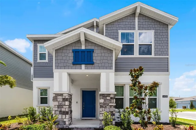 a front view of a house with plants