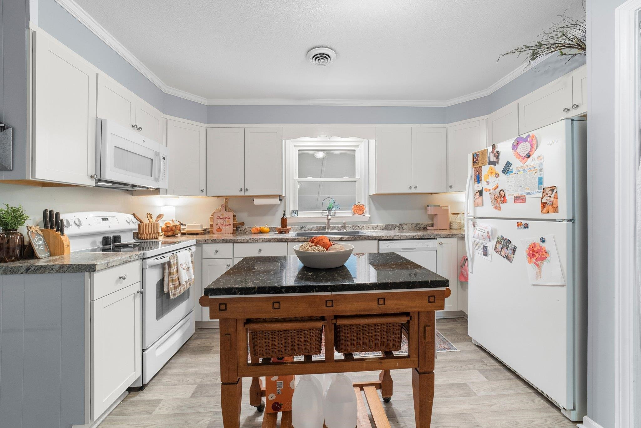 1818 Wellington Road Burlington, NC 27217 - Photo 16 of 36 a kitchen with a refrigerator and cabinets
