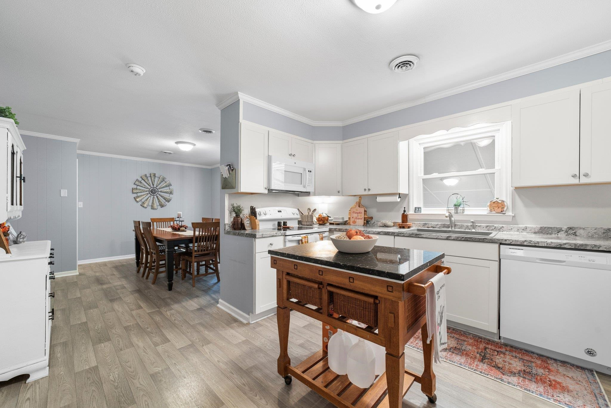 1818 Wellington Road Burlington, NC 27217 - Photo 17 of 36 a kitchen with a table and chairs in it