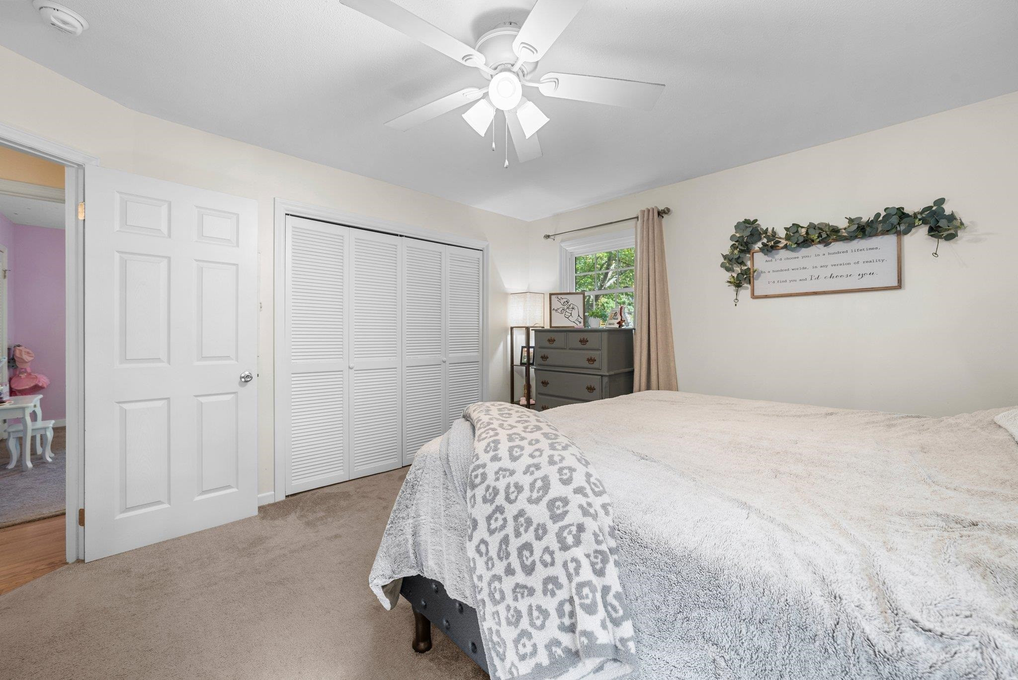 1818 Wellington Road Burlington, NC 27217 - Photo 28 of 36 a bedroom with a bed and a chandelier