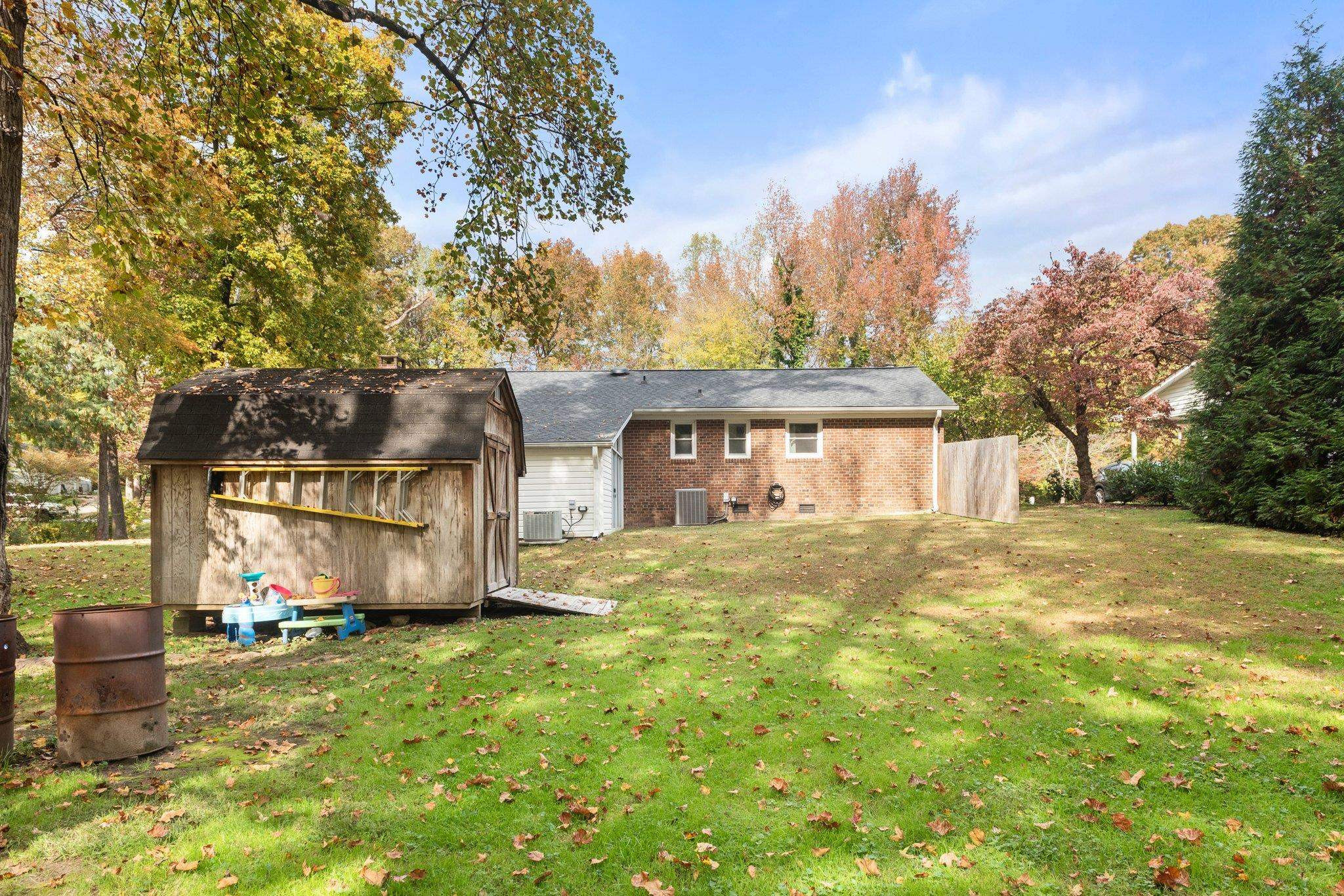 1818 Wellington Road Burlington, NC 27217 - Photo 34 of 36 a view of a big house with a big yard and large trees