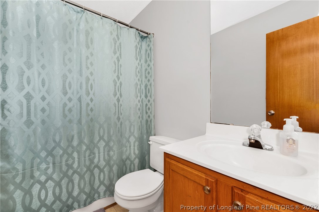 169 Robeson Street Spring Lake, NC 28390 - Photo 21 of 35 a bathroom with a sink a toilet and shower curtain