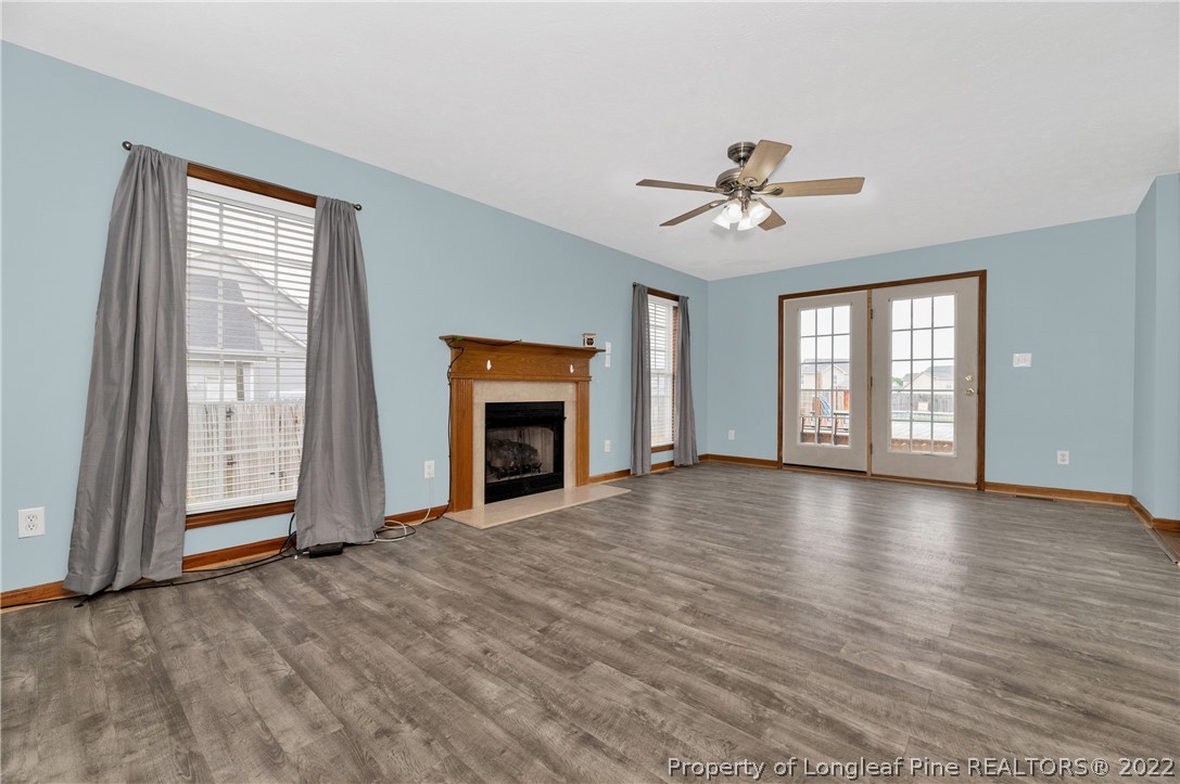 169 Robeson Street Spring Lake, NC 28390 - Photo 9 of 35 wooden floor fireplace and windows in an empty room