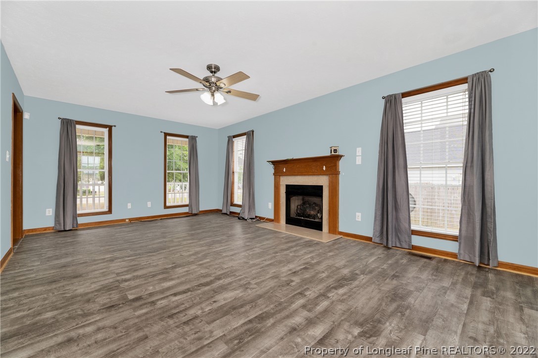 169 Robeson Street Spring Lake, NC 28390 - Photo 10 of 35 wooden floor fireplace and windows in an empty room