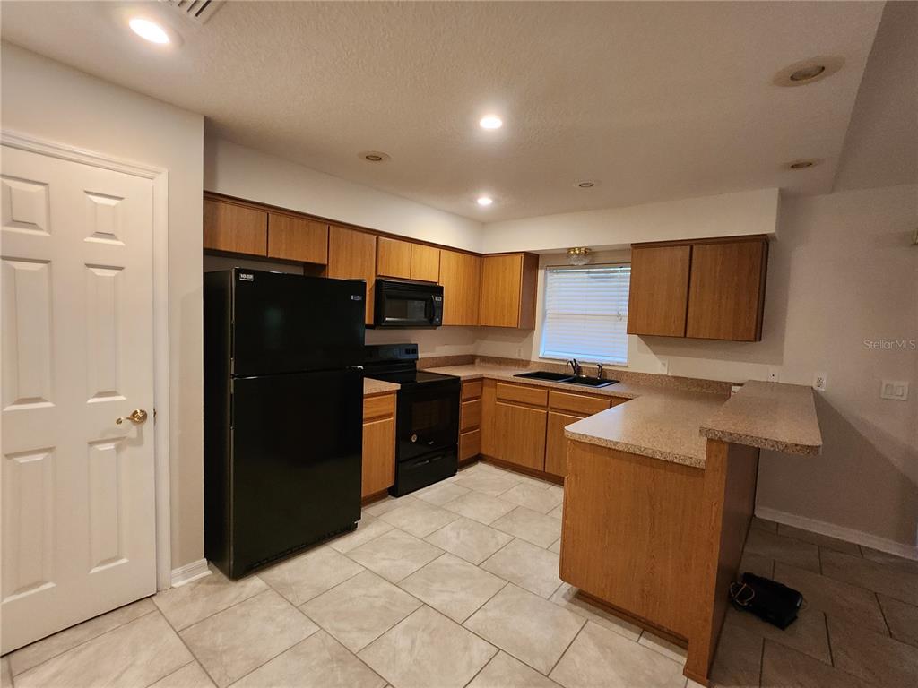 6521 East Grayson Street Inverness, FL 34452 - Photo 5 of 16 a kitchen with stainless steel appliances granite countertop a refrigerator stove and sink
