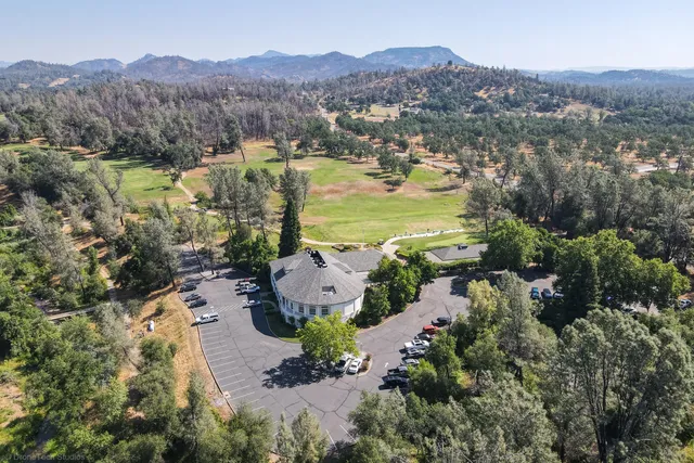 an aerial view of lake residential house and sandy dunes
